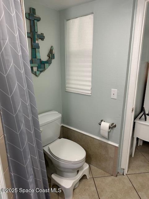 bathroom with tile patterned flooring and toilet