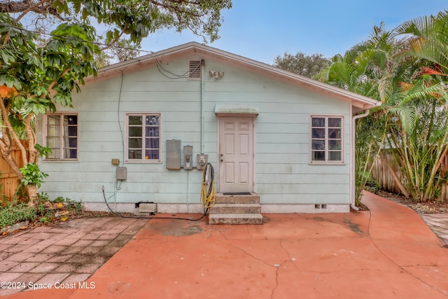 back of property with a patio