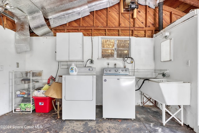 clothes washing area featuring washer and clothes dryer and sink