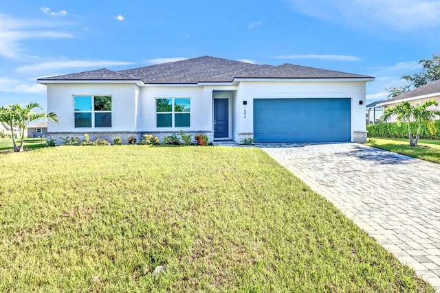 view of front facade with a garage and a front lawn