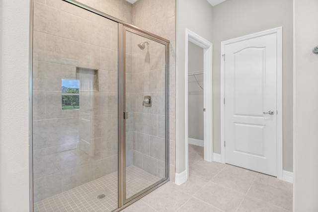 bathroom featuring tile patterned floors and a shower with door