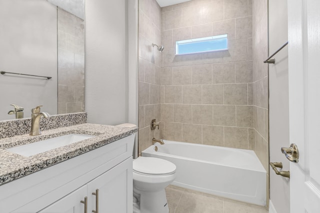 full bathroom with tile patterned flooring, vanity, tiled shower / bath combo, and toilet