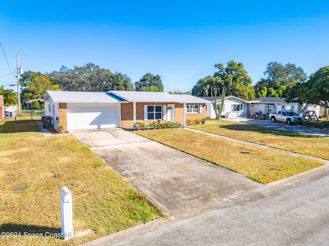 single story home with a front yard and a garage