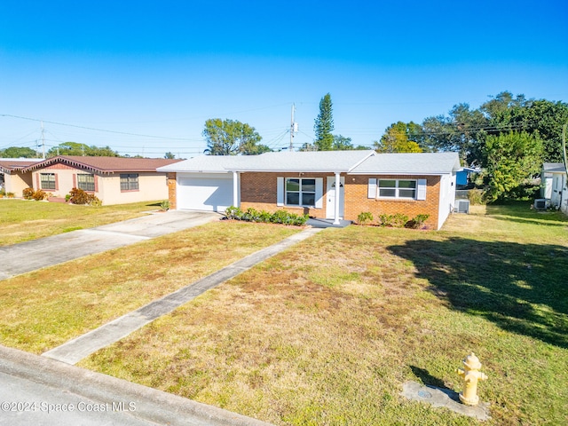 view of front of home with a garage and a front lawn