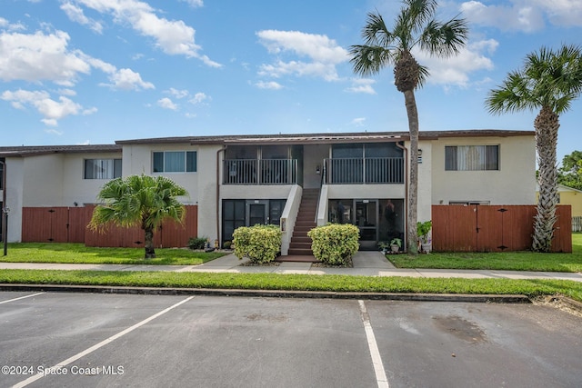 641 Ridge Club Dr Unit 21, Melbourne, FL 32934 - view of property with uncovered parking and stairway