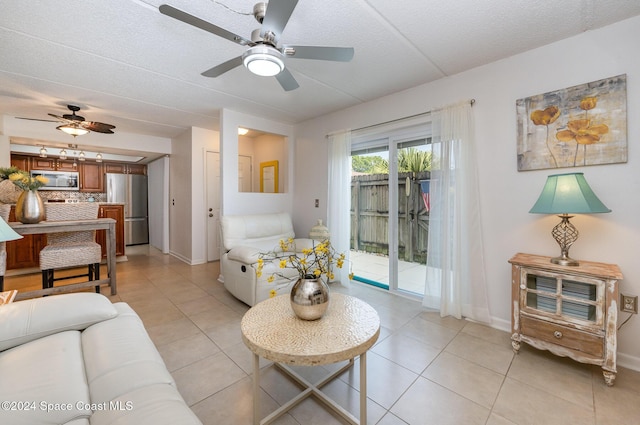 641 Ridge Club Dr Unit 21, Melbourne, FL 32934 - living room featuring light tile patterned floors, baseboards, a ceiling fan, and a textured ceiling