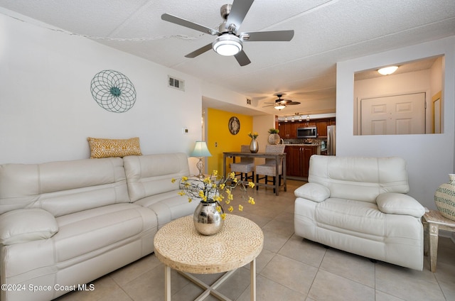 641 Ridge Club Dr Unit 21, Melbourne, FL 32934 - living room with light tile patterned floors and ceiling fan