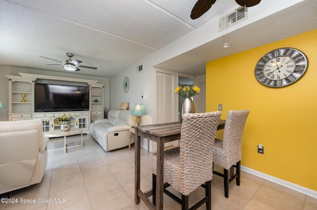 641 Ridge Club Dr Unit 21, Melbourne, FL 32934 - dining room with a ceiling fan, light tile patterned flooring, baseboards, and a textured ceiling