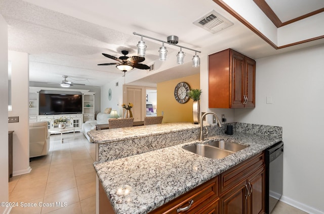 641 Ridge Club Dr Unit 21, Melbourne, FL 32934 - kitchen with a sink, ceiling fan, stainless steel dishwasher, a peninsula, and light stone countertops