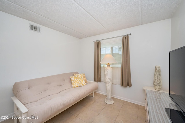 641 Ridge Club Dr Unit 21, Melbourne, FL 32934 - living area featuring light tile patterned floors, a textured ceiling, and baseboards