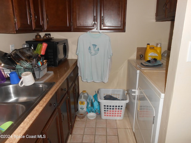 laundry room with independent washer and dryer, sink, and light tile patterned floors