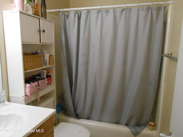 full bathroom with vanity, shower / bath combo, and toilet