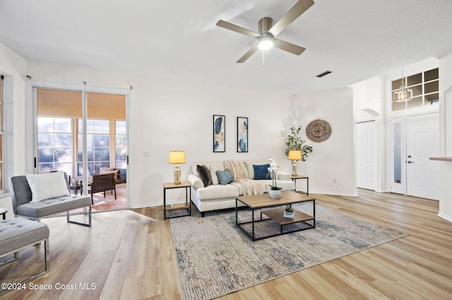 living room with hardwood / wood-style flooring and ceiling fan