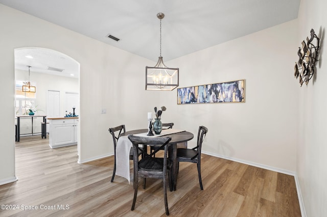 dining space featuring a chandelier and light hardwood / wood-style floors