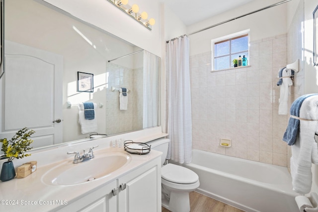 full bathroom with toilet, shower / tub combo with curtain, vanity, and hardwood / wood-style flooring