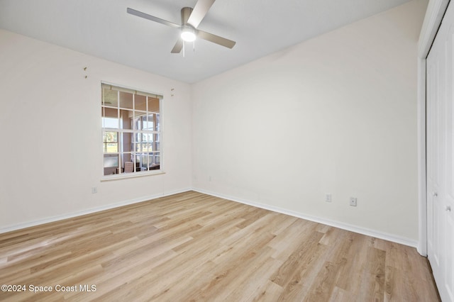 unfurnished room with ceiling fan and light wood-type flooring