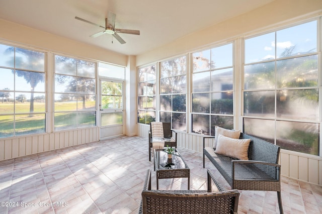 sunroom / solarium with a wealth of natural light and ceiling fan