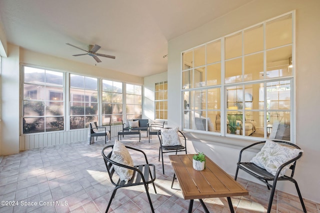 sunroom / solarium featuring ceiling fan