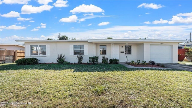 ranch-style house with a front yard and a garage