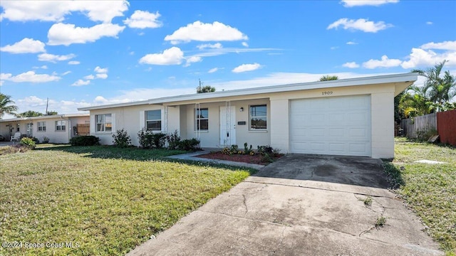 single story home featuring a front lawn and a garage