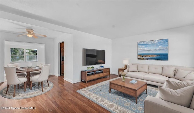 living room featuring hardwood / wood-style flooring and ceiling fan