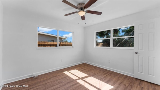 spare room with ceiling fan and wood-type flooring