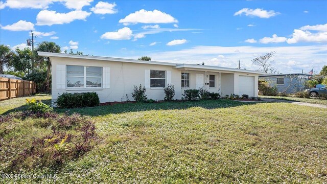 single story home featuring a garage and a front lawn