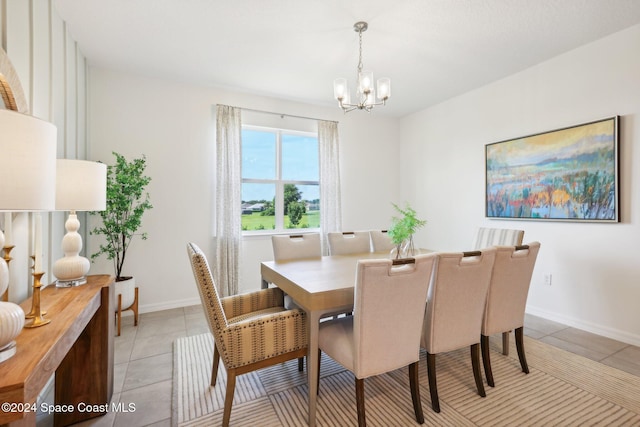 dining space with light tile patterned floors and a notable chandelier