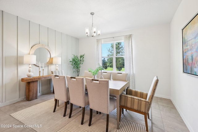 dining room featuring light tile patterned floors and a chandelier