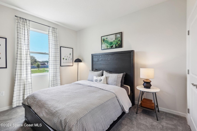 carpeted bedroom featuring multiple windows