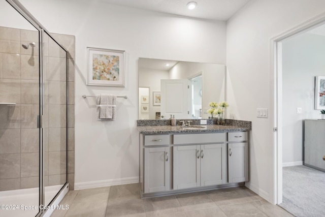 bathroom featuring tile patterned floors, vanity, and a shower with shower door