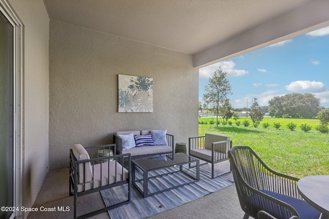 view of patio with an outdoor living space and a rural view