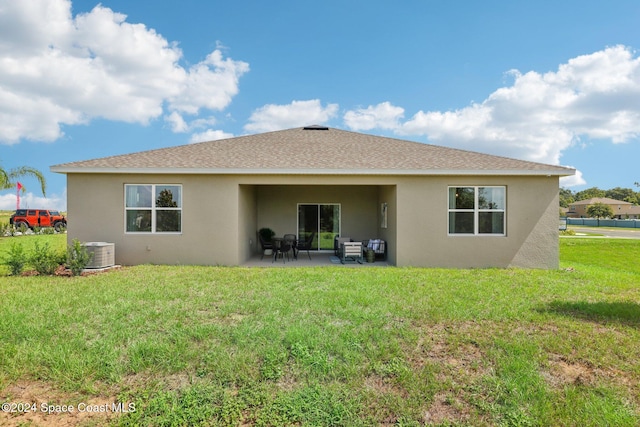 back of property featuring a patio, central AC unit, and a lawn