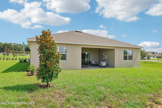 rear view of property with a patio area and a lawn