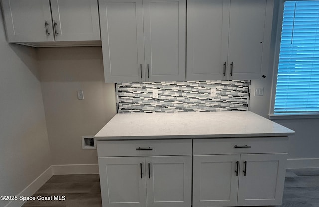 kitchen featuring tasteful backsplash, dark wood-type flooring, and white cabinets