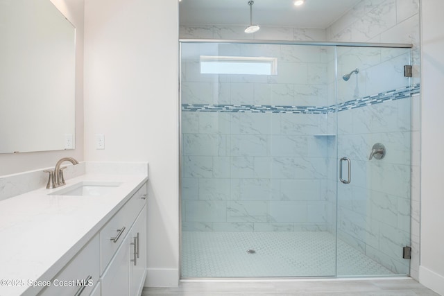 bathroom featuring vanity and an enclosed shower