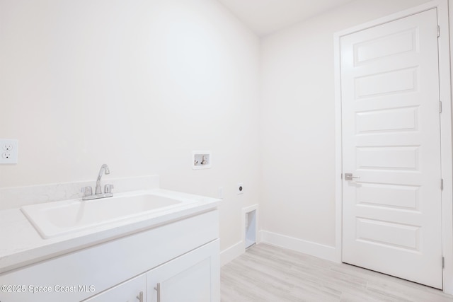 clothes washing area with sink, cabinets, hookup for a washing machine, electric dryer hookup, and light hardwood / wood-style floors