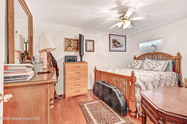 bedroom with ceiling fan and light wood-type flooring