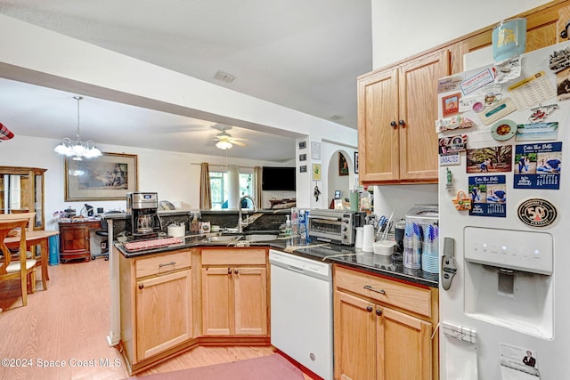 kitchen with light brown cabinets, white appliances, ceiling fan with notable chandelier, light hardwood / wood-style floors, and kitchen peninsula