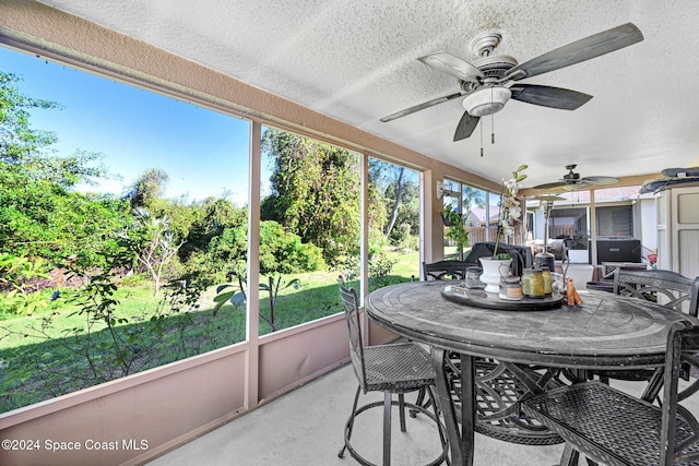 sunroom / solarium featuring ceiling fan