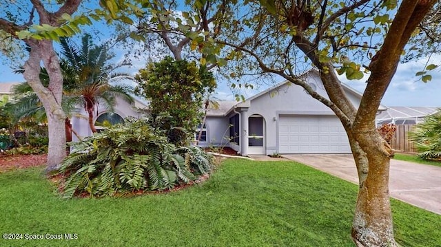 view of front of house with a front yard and a garage