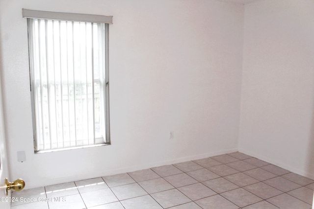 unfurnished room featuring light tile patterned floors