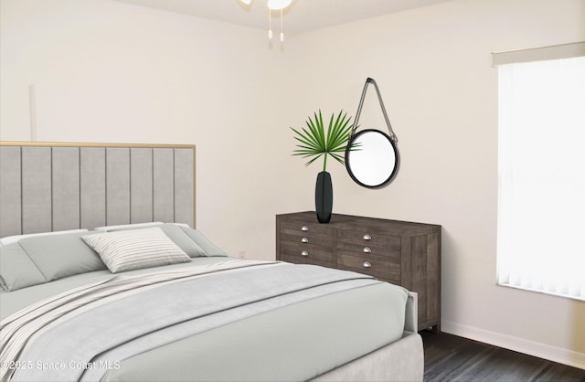 bedroom with dark wood finished floors and baseboards