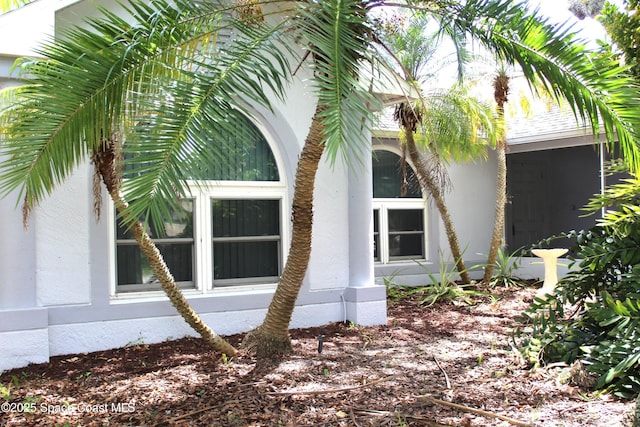 view of side of property featuring stucco siding