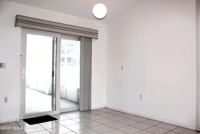 unfurnished room featuring baseboards and light tile patterned floors