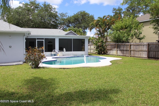 view of swimming pool with a fenced in pool, a sunroom, a yard, and fence