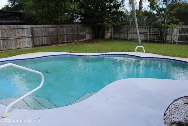 view of swimming pool featuring a fenced in pool, a fenced backyard, and a yard