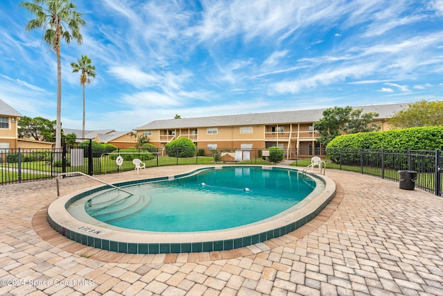 view of swimming pool with a patio