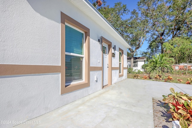 view of side of home featuring a patio