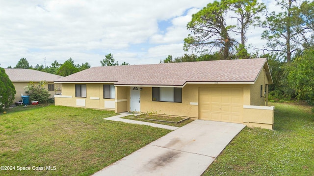 single story home featuring a front lawn and a garage